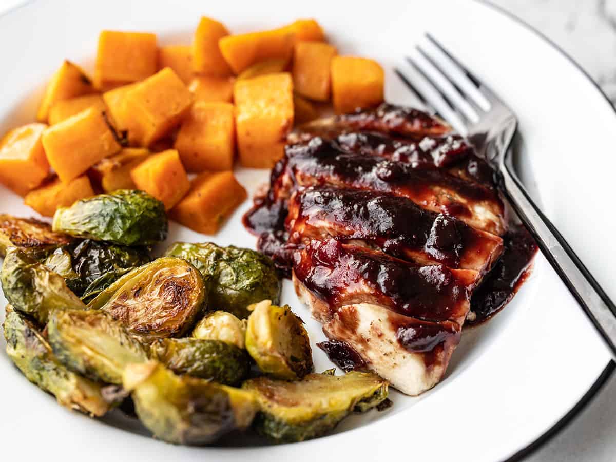 Sheet Pan Cranberry Chicken Dinner on a plate, viewed from the side