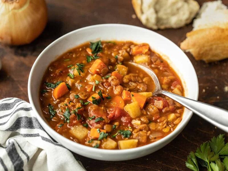 front view of a bowl full of tomato lentil soup