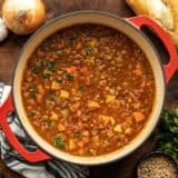 Overhead view of a pot full of tomato lentil soup