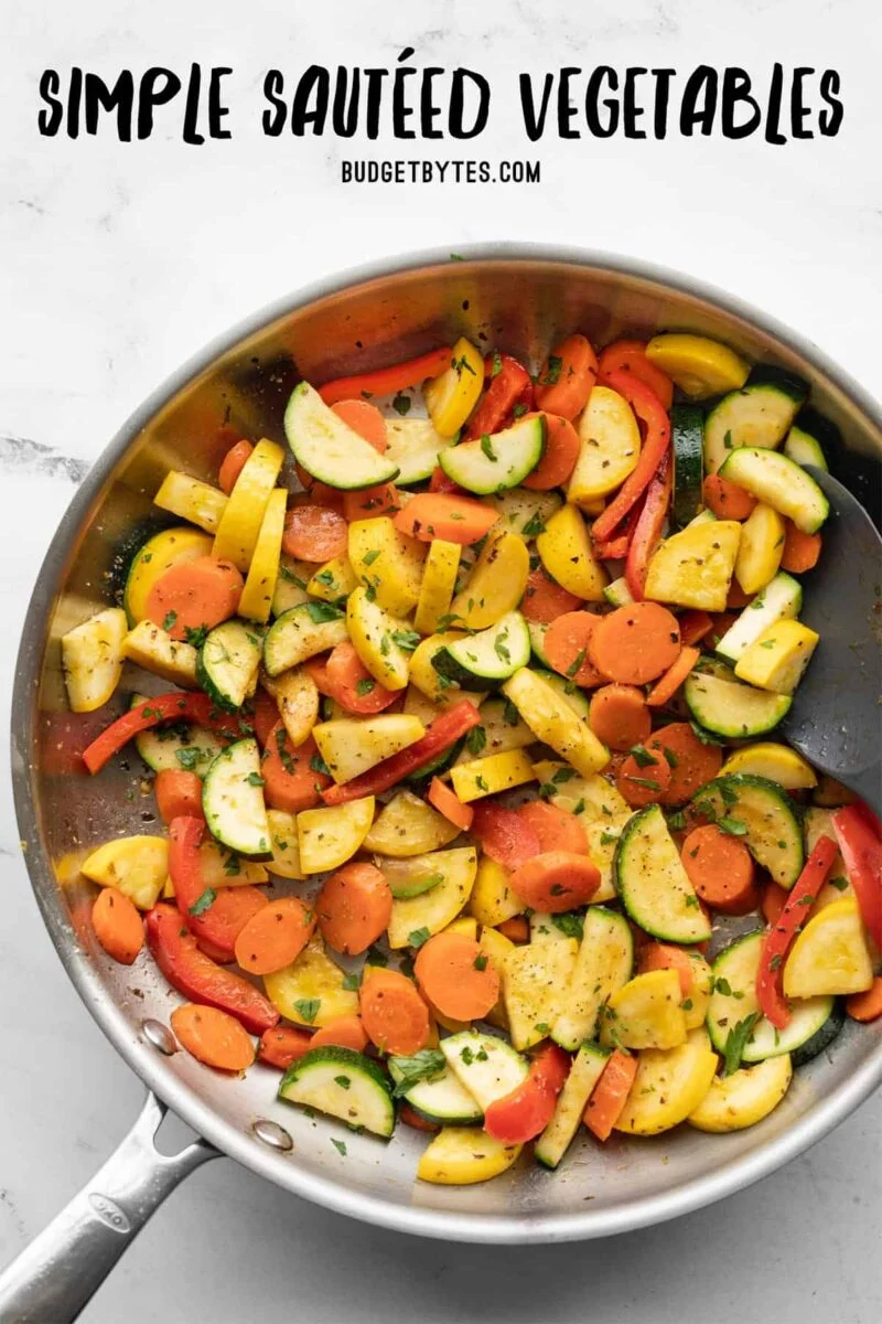 Overhead view of sautéed vegetables in a skillet with title text at the top