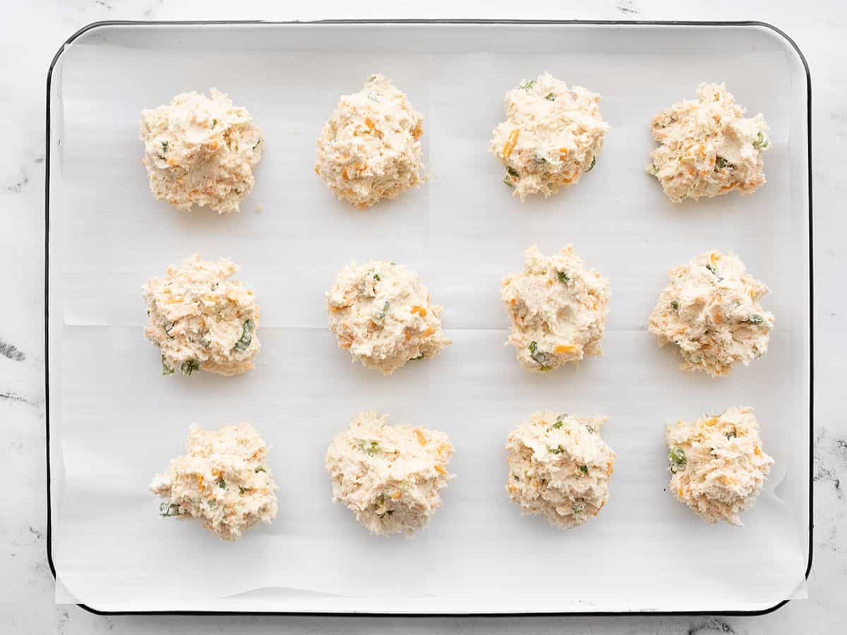 Biscuit batter dropped into clumps on the baking sheet