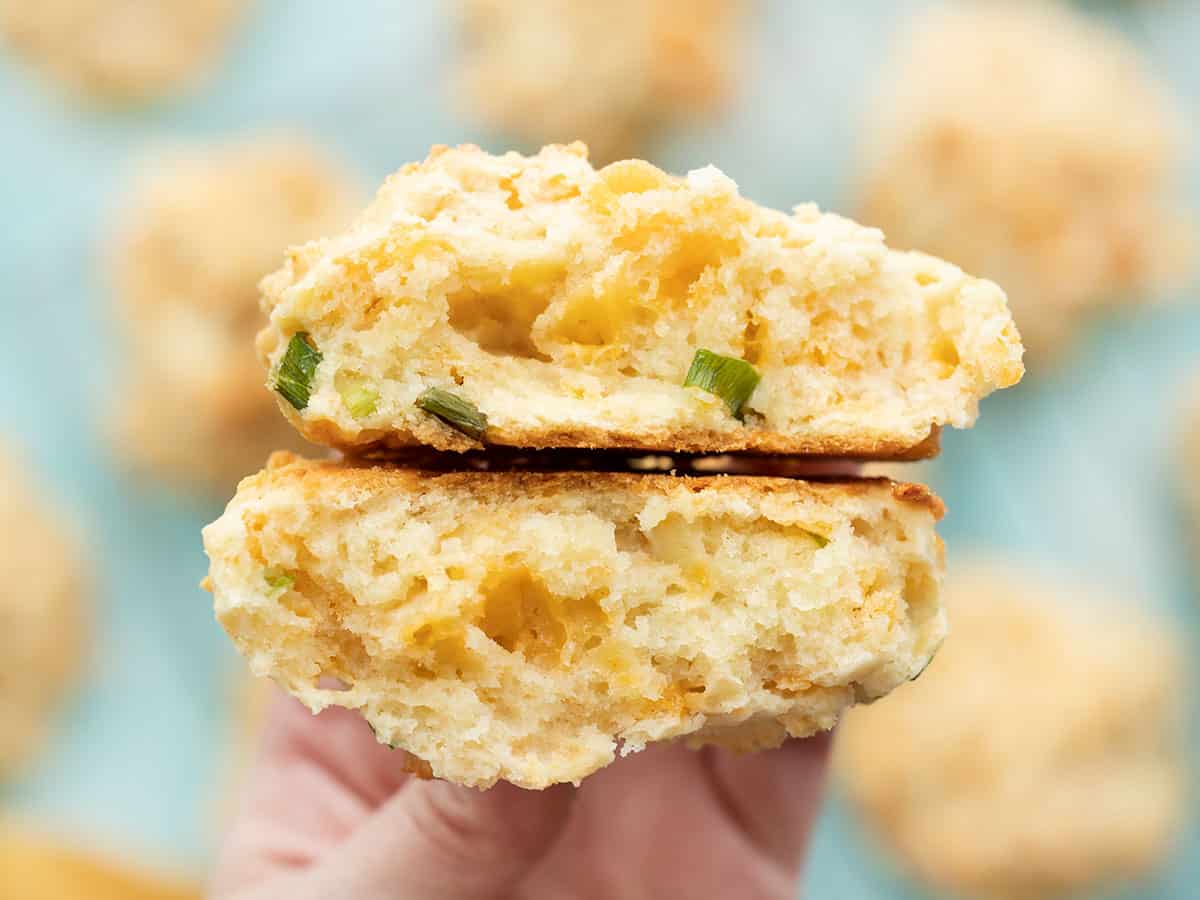 A cheddar drop biscuit cut in half, open sides facing camera