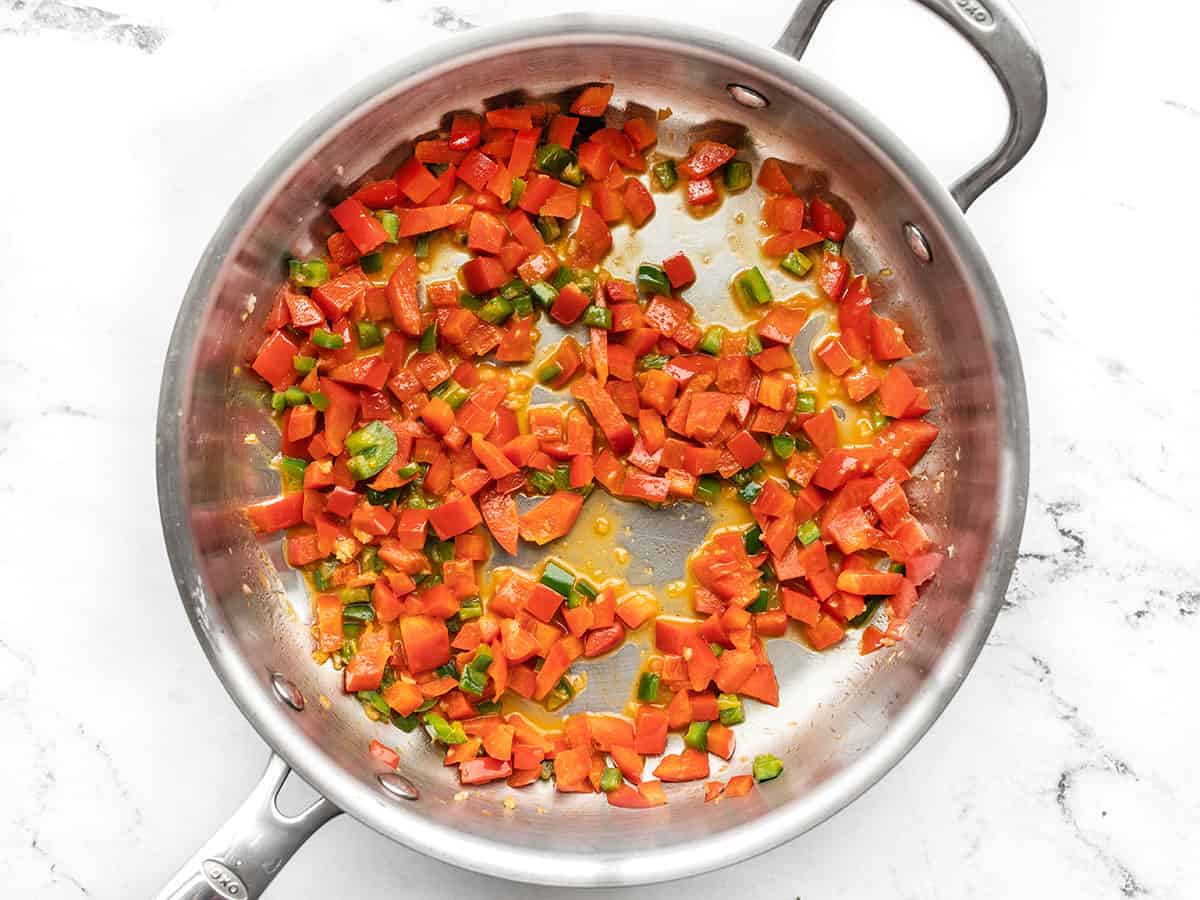 Diced peppers and garlic in a skillet