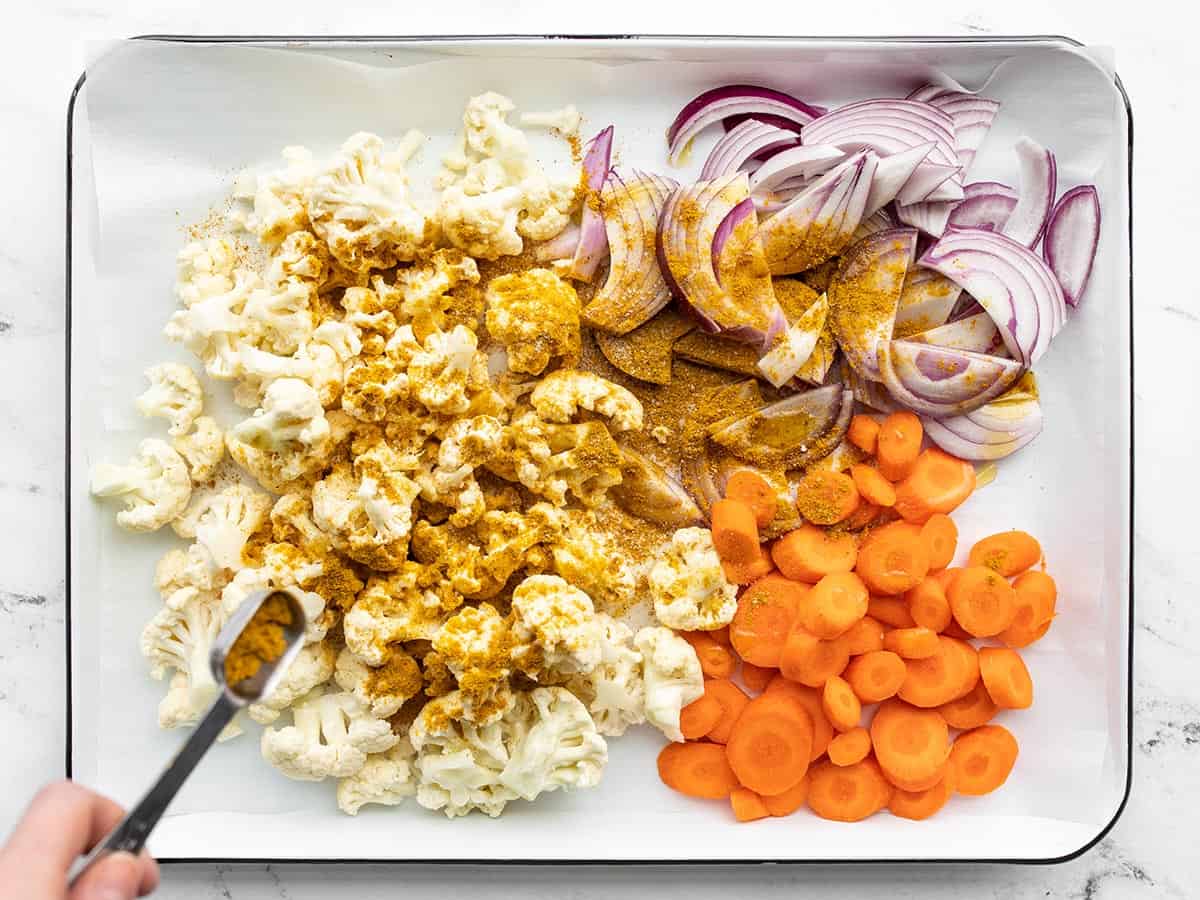 Olive oil and curry powder added to the chopped vegetables