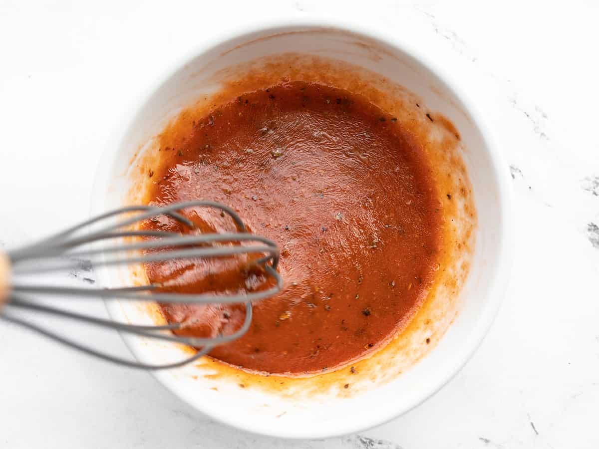 Tomato Basil Vinaigrette being whisked in the bowl