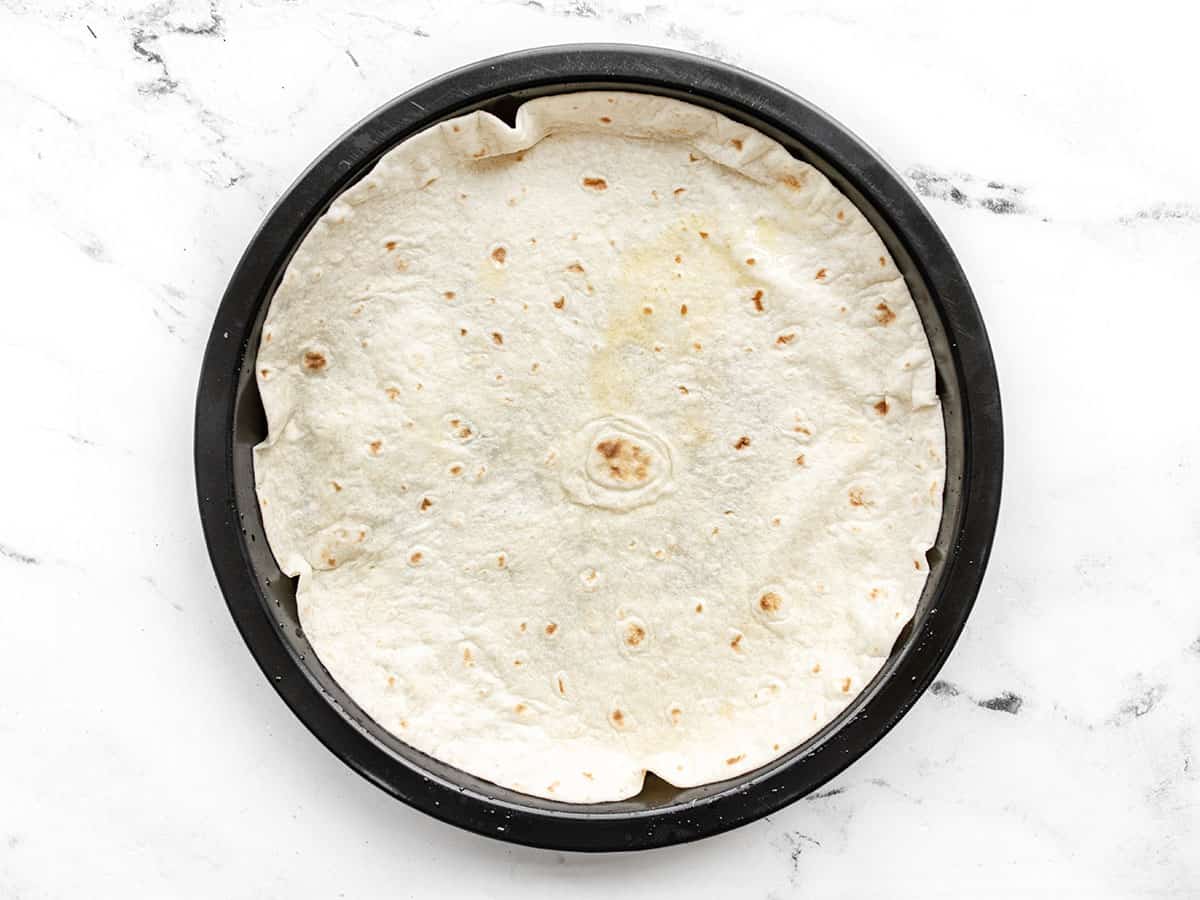 Tortilla pressed into baking dish