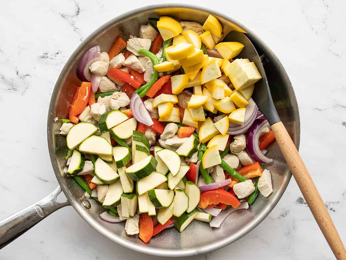 zucchini and yellow squash added to the skillet