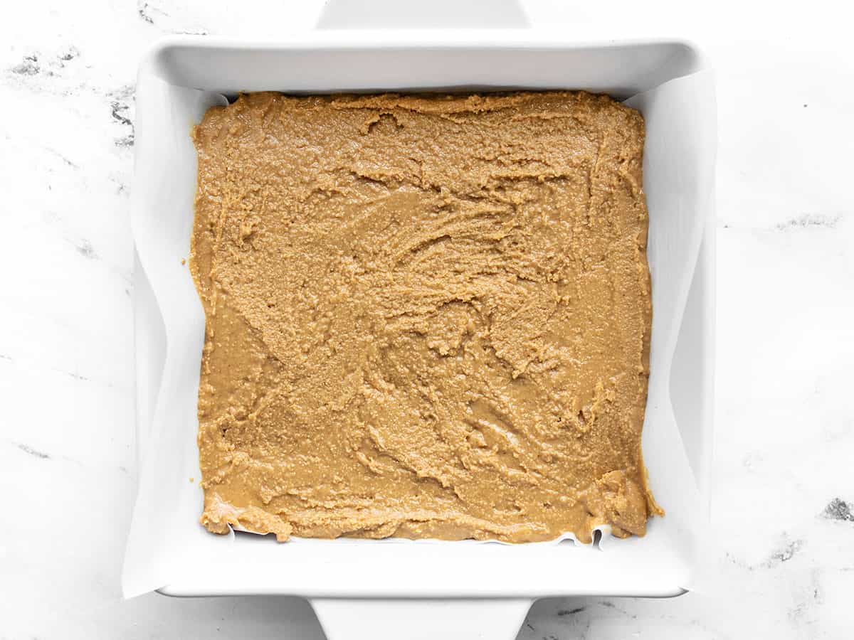 peanut butter base spread into a parchment lined baking dish