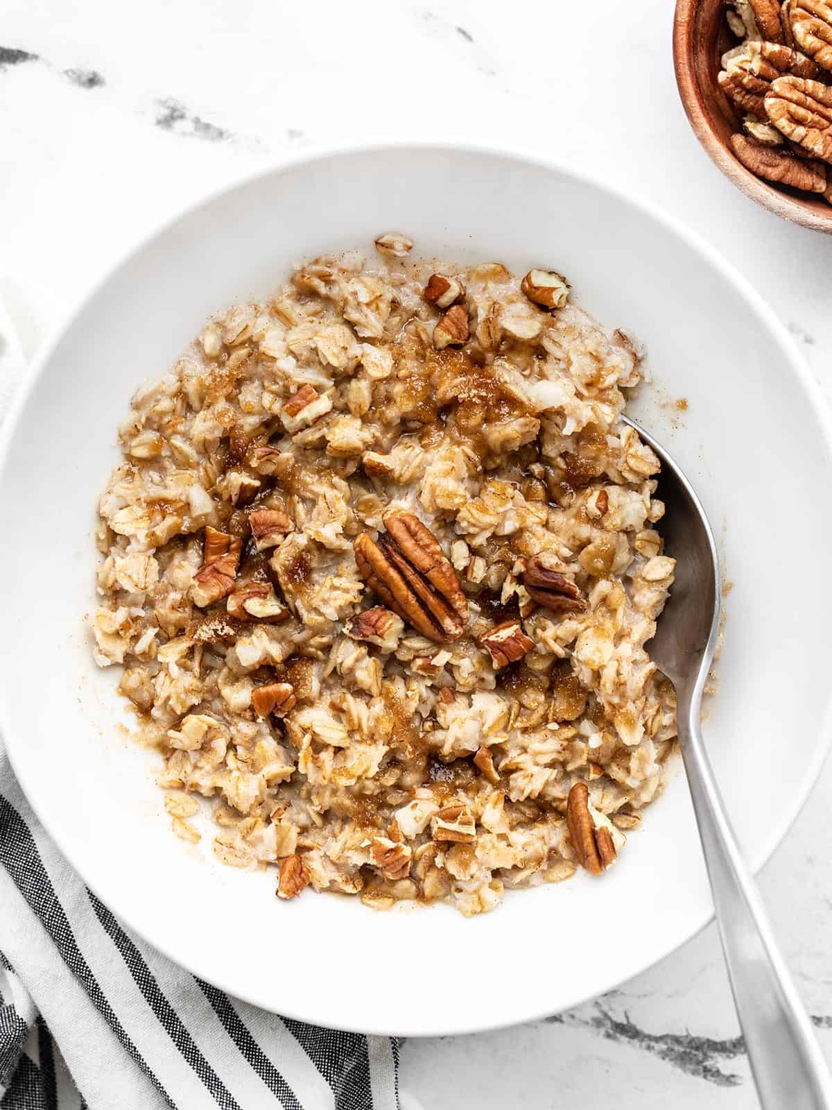 Overhead view of a bowl of cauliflower oatmeal with a spoon in the side