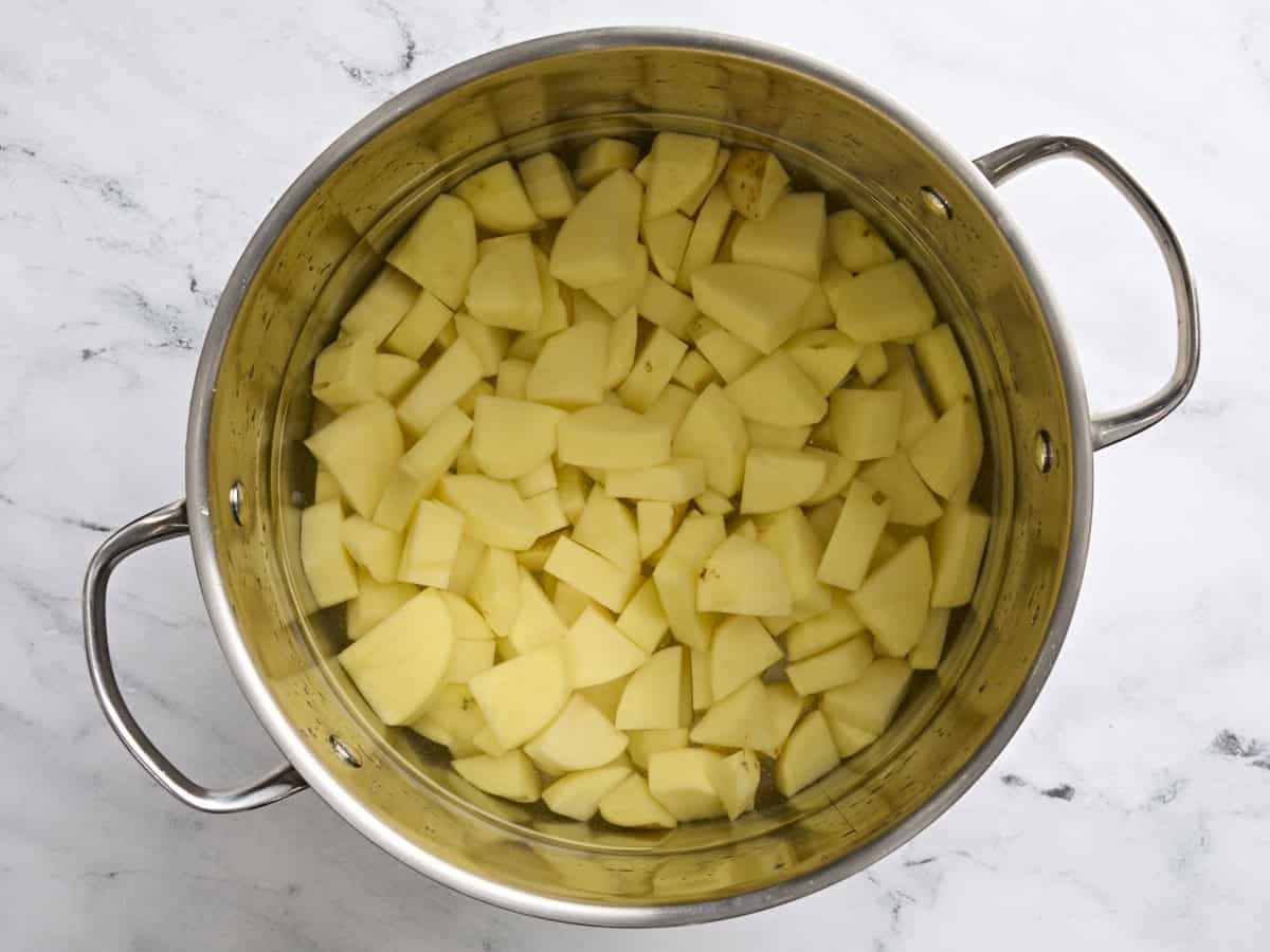 Cubed potatoes in a pot of water.