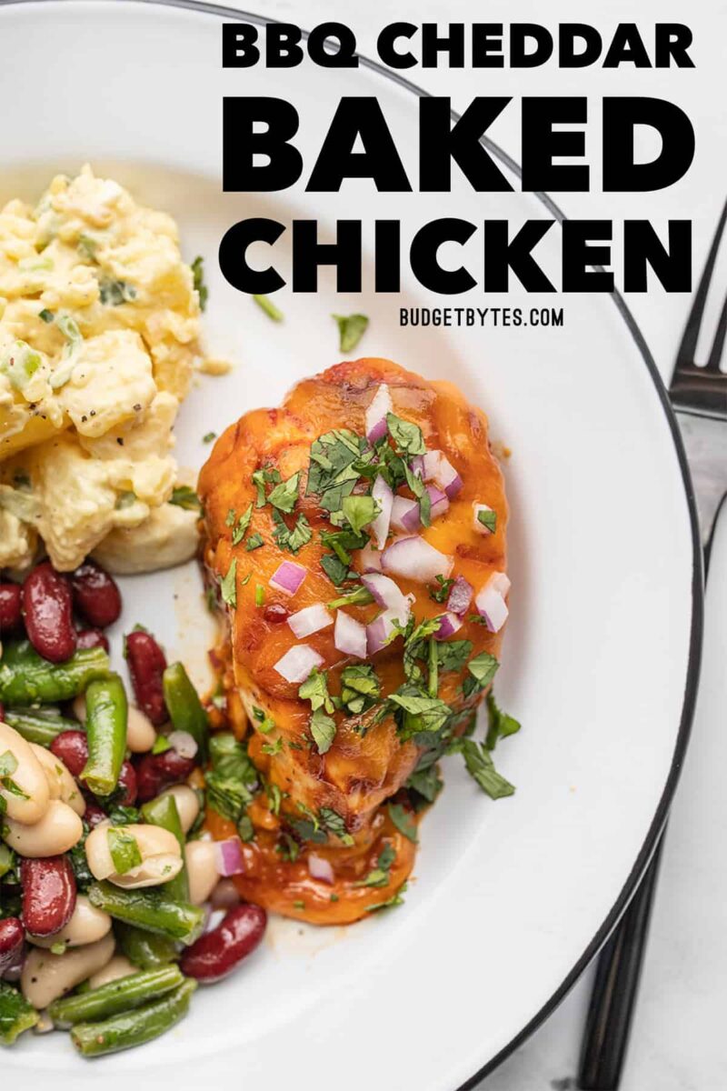 BBQ Cheddar Baked Chicken on a plate with sides, title text at the top