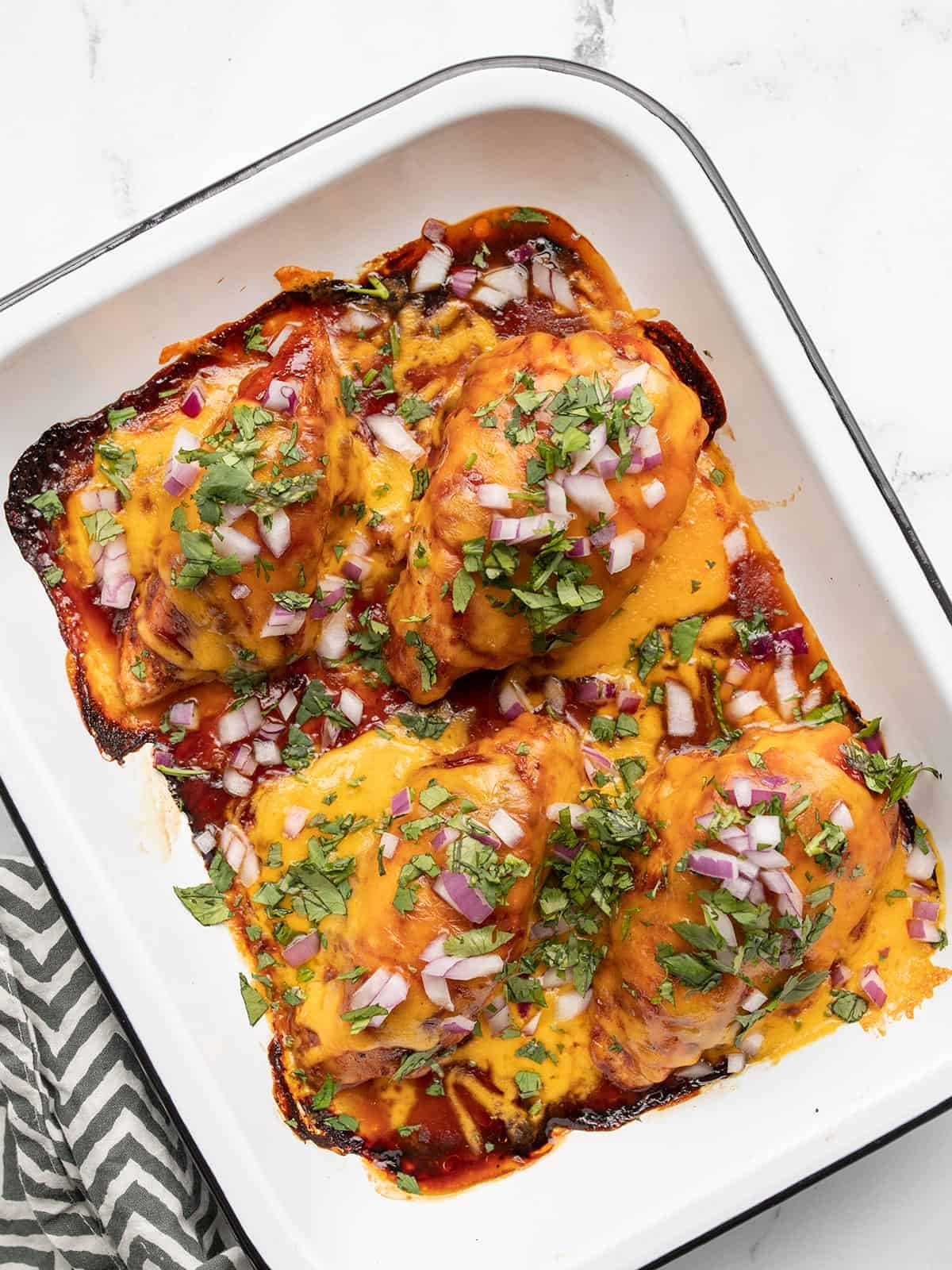 Overhead view of BBQ Cheddar Baked Chicken in a baking dish