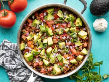 overhead view of beef and cauliflower taco skillet with vegetables on the sides