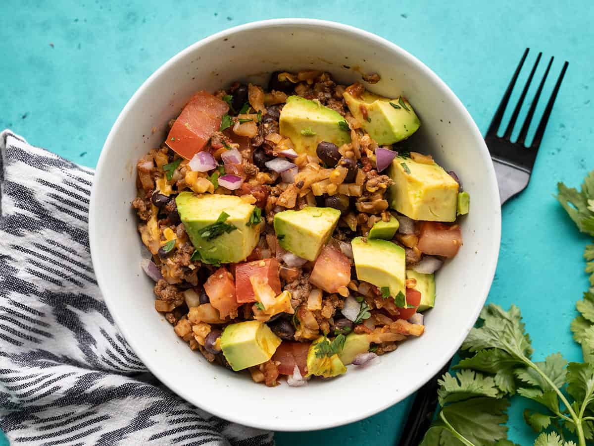 beef and cauliflower taco skillet in a bowl with a fork on the side