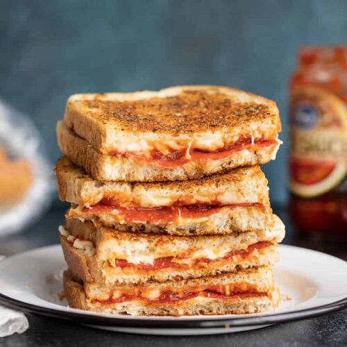 A stack of pizza melts, cut sides facing camera