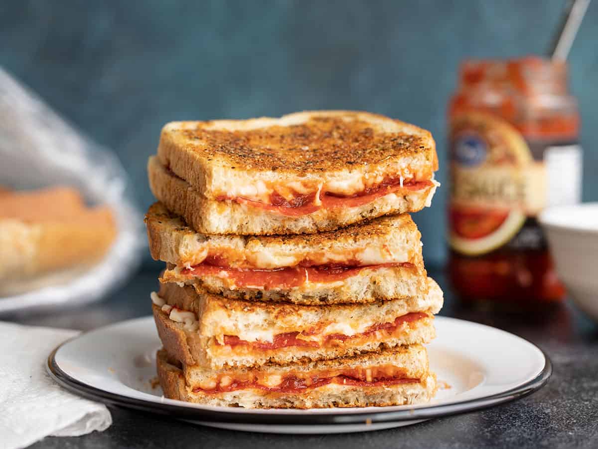 A stack of pizza melts, cut sides facing camera