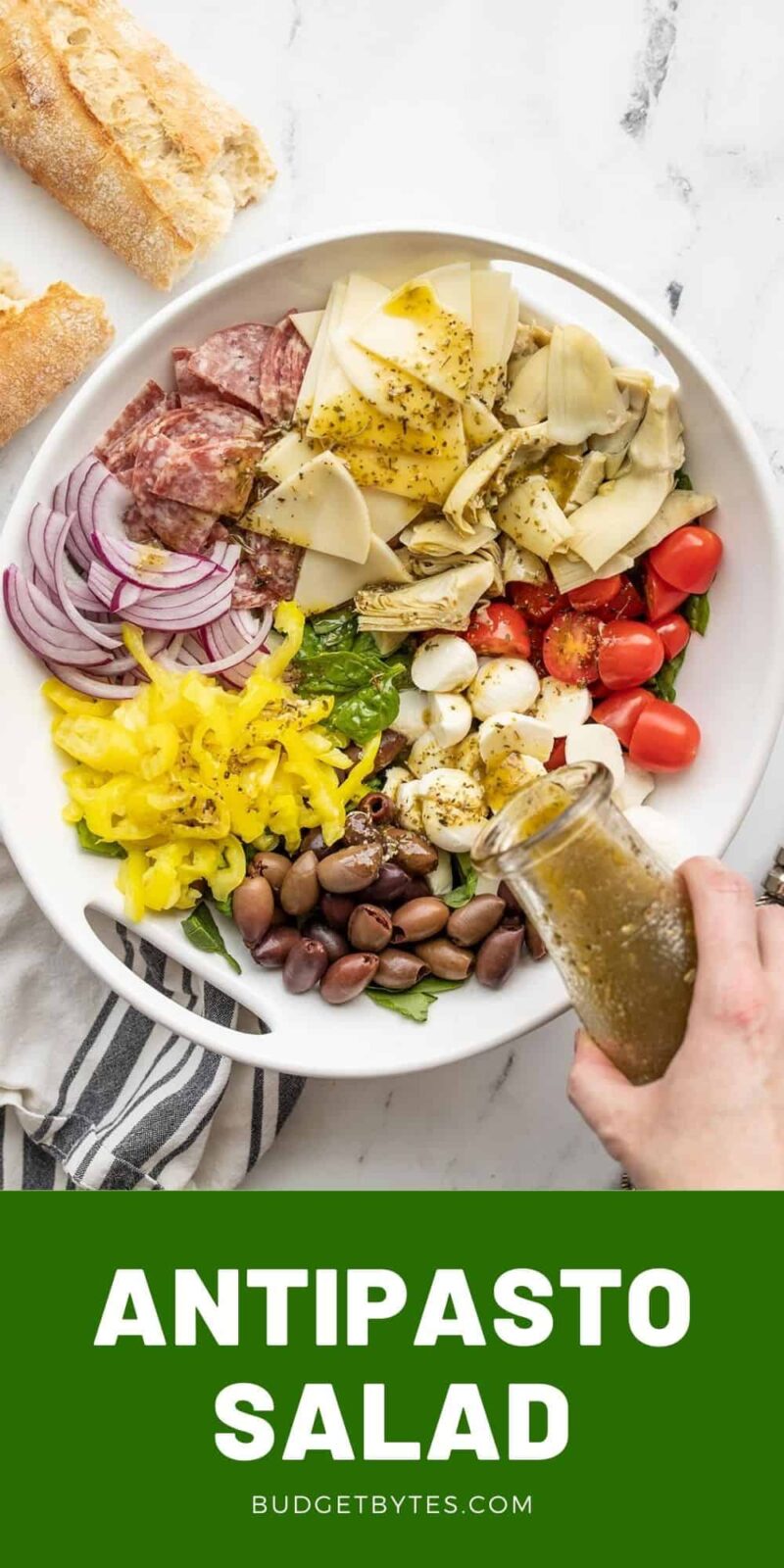 dressing being poured over an antipasto salad, title text at the bottom