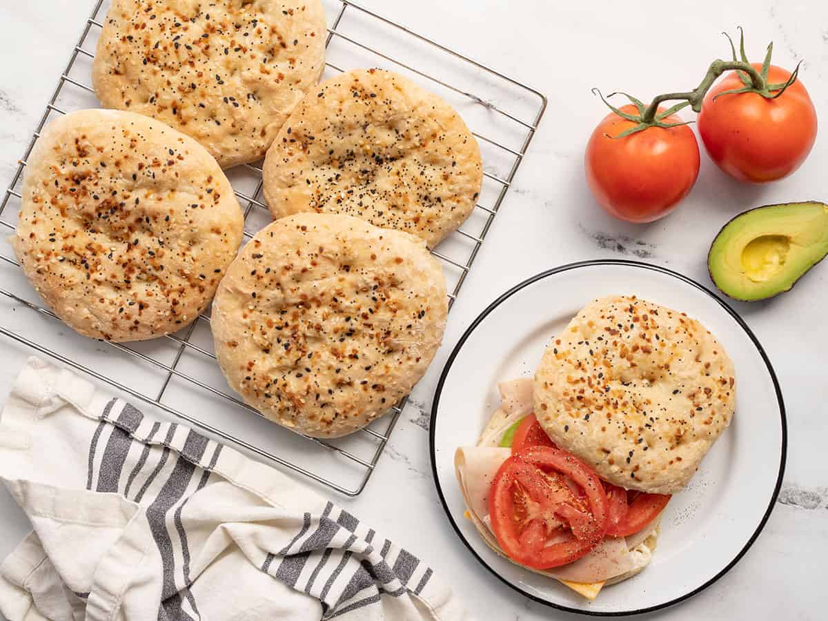 A sandwich made with the EBTB Sandwich round next to the rest of the batch on a cooling rack