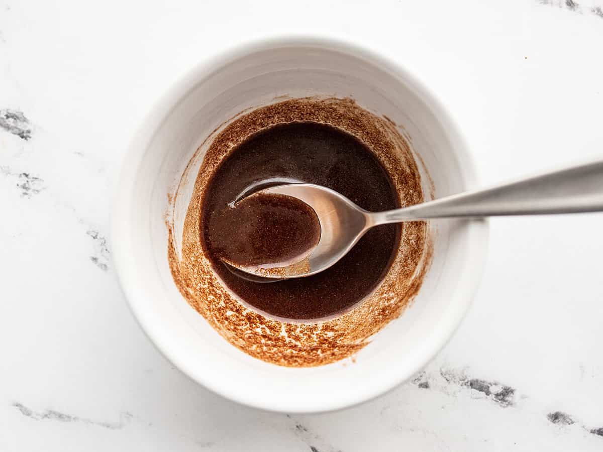 metled butter, brown sugar, and cinnamon in a bowl with a spoon