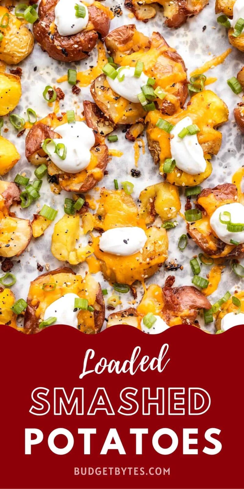 overhead view of loaded smashed potatoes on a baking sheet, title text at the bottom