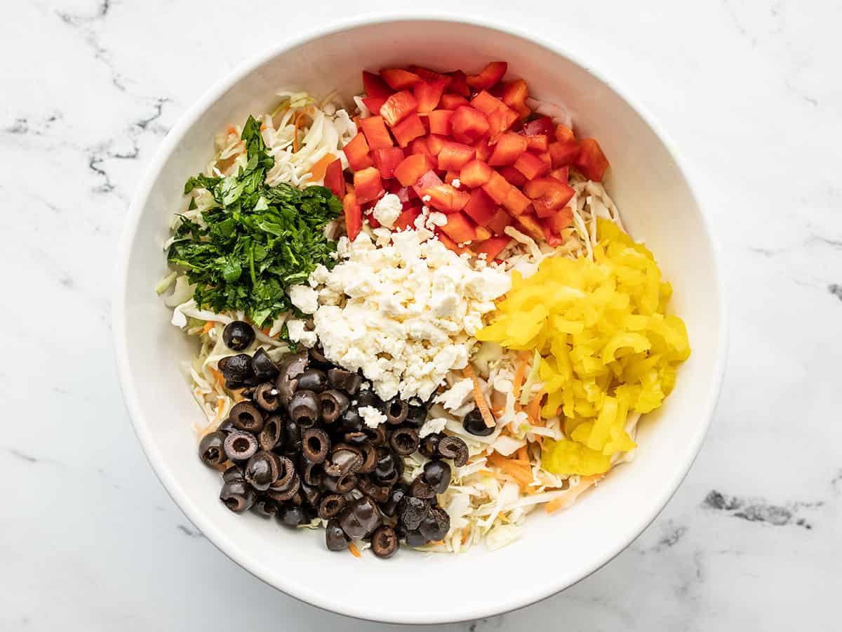 prepped vegetables for mediterranean slaw in a bowl