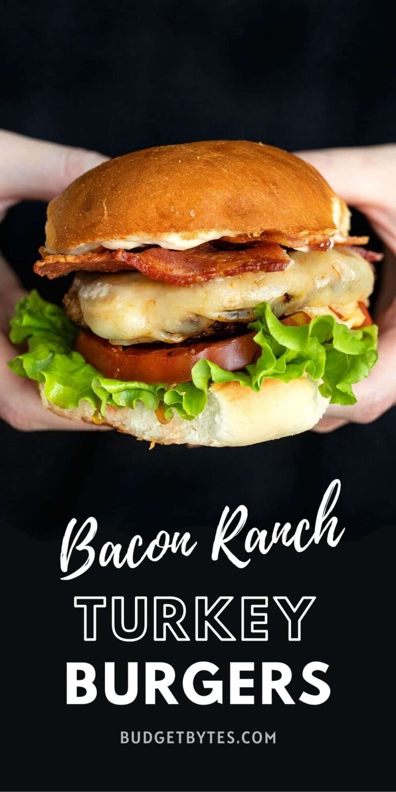 a single bacon ranch turkey burger held in hands, title text at the bottom