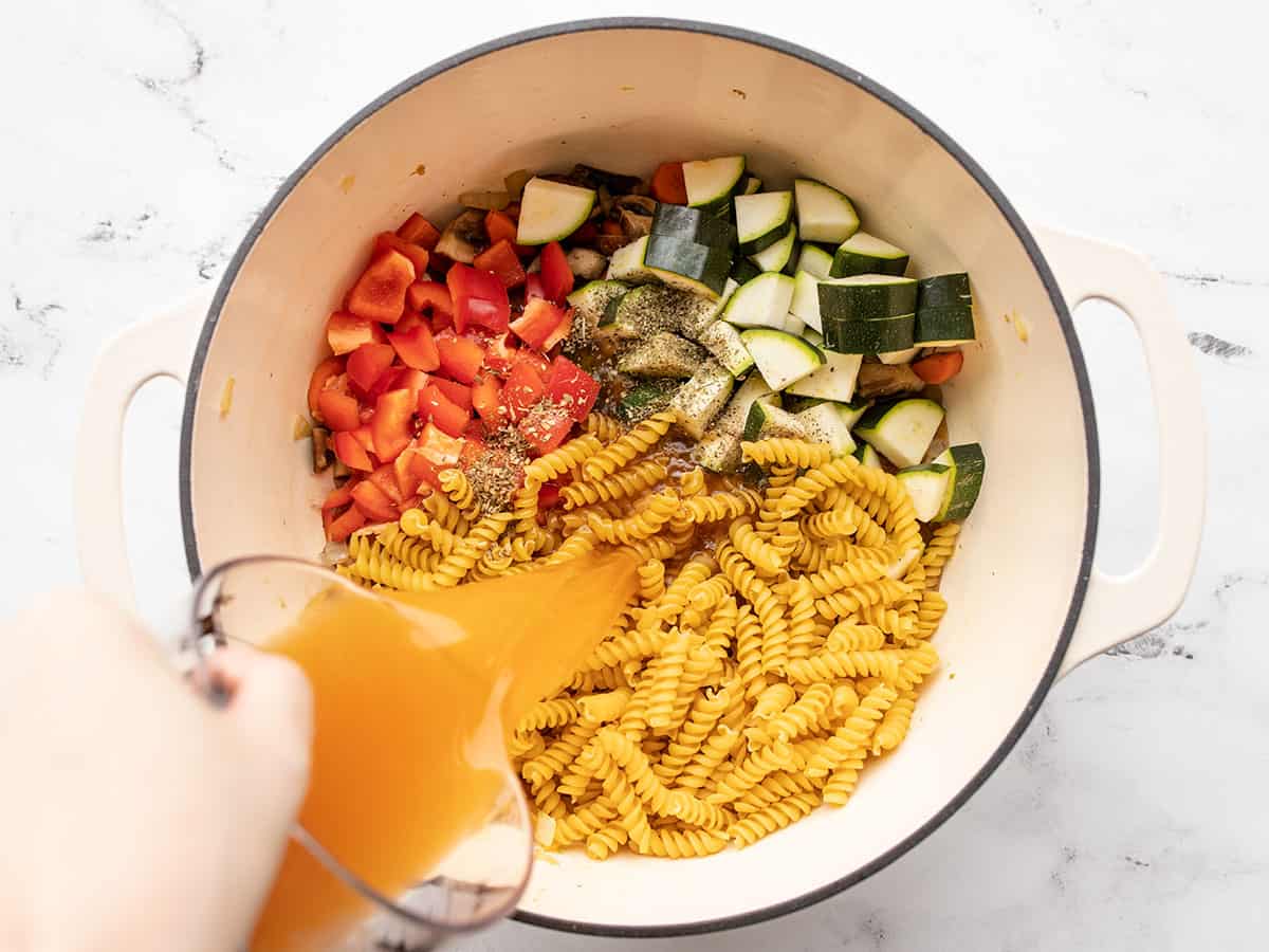 pasta, vegetables, and broth added to the pot