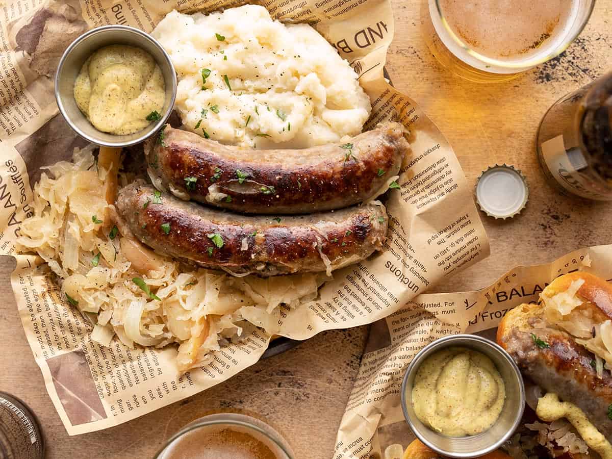 Bratwurst and sauerkraut on a plate with mashed potatoes and mustard