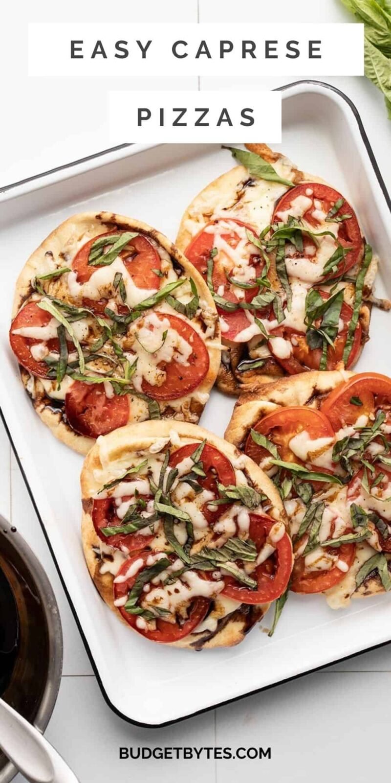 Four Caprese pizzas on a tray, title text at the top