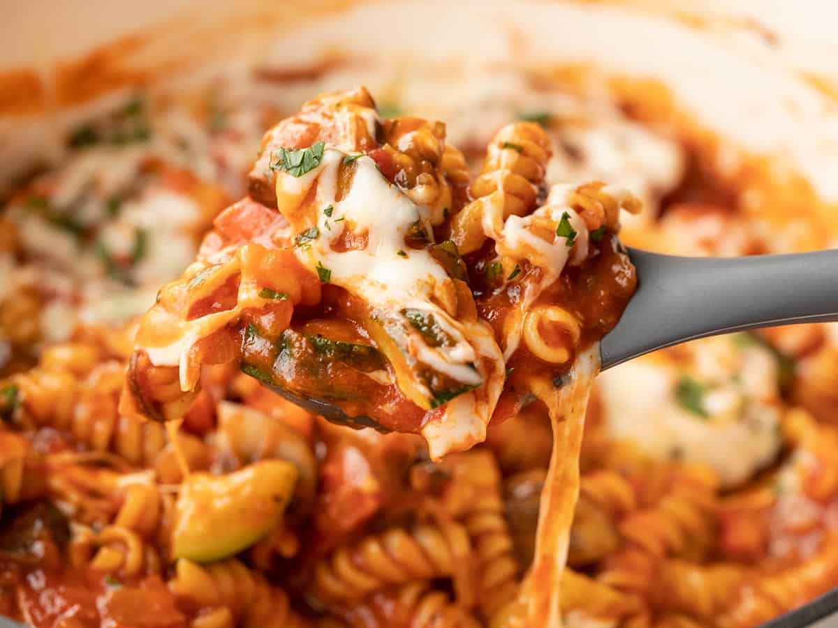 Close up of one pot veggie pasta being lifted on a spoon