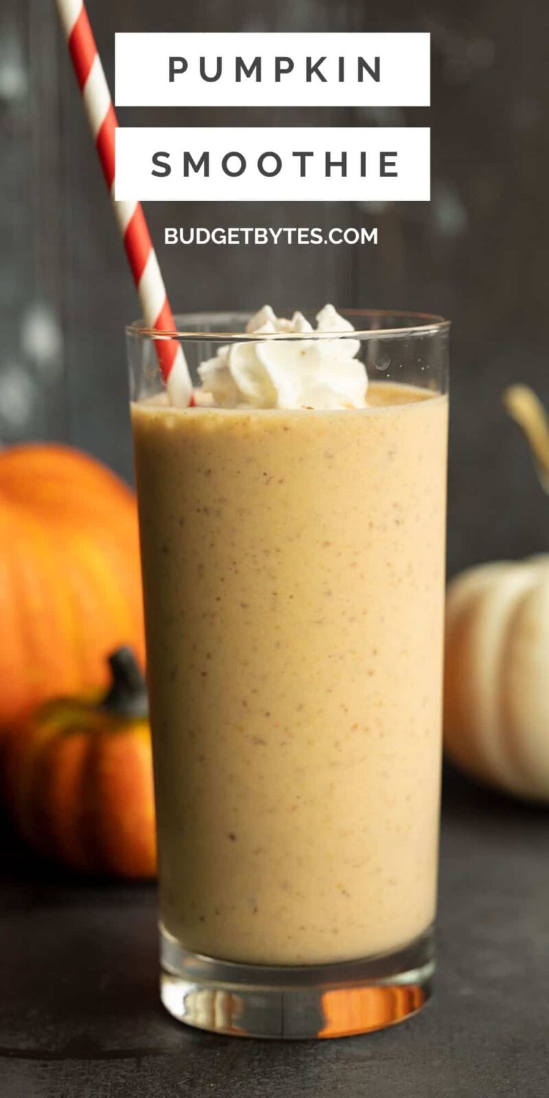 a tall glass full of pumpkin smoothie with whipped cream, title text at the top