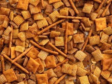 Close up of spicy chex mix on the baking sheet