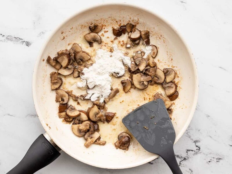 sautéed mushrooms in the skillet with flour