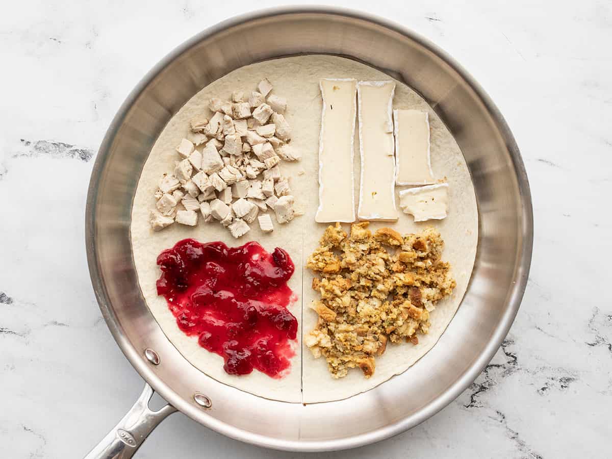 Filling ingredients on the tortilla in a skillet