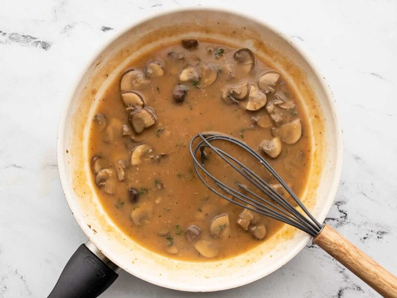 finished gravy in the skillet with a whisk