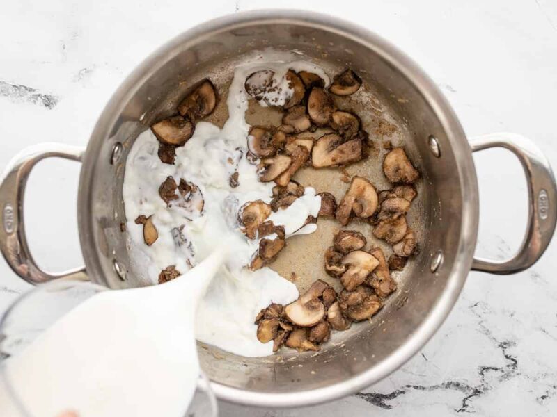 milk being poured into the pot