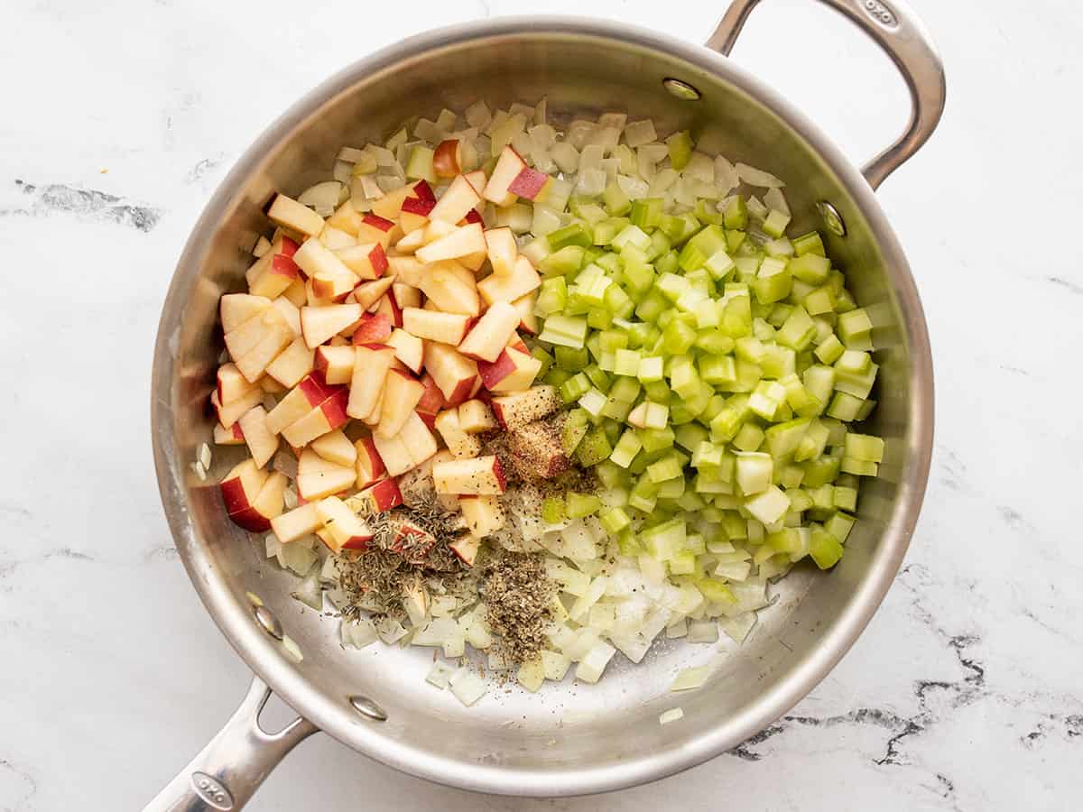 apples, celery, and seasoning added to the skillet