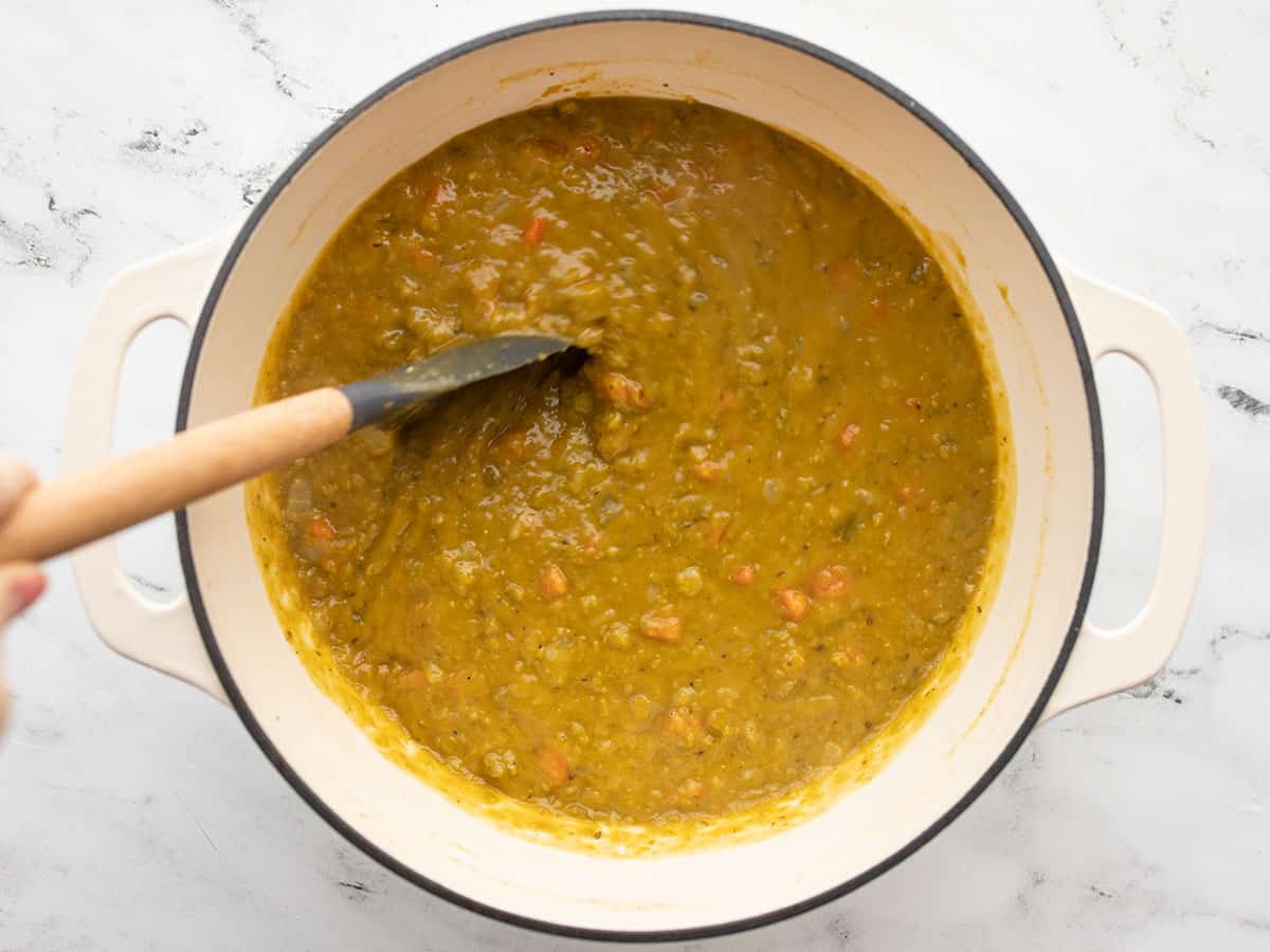 Thickened split pea soup being stirred