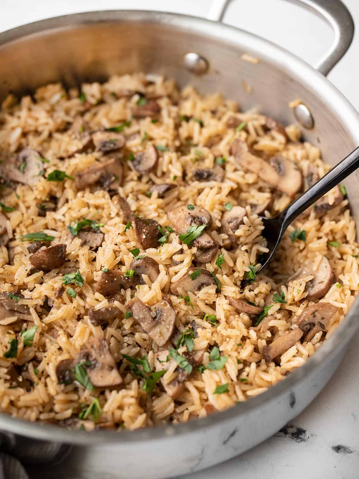 Side view of mushroom rice in a pan