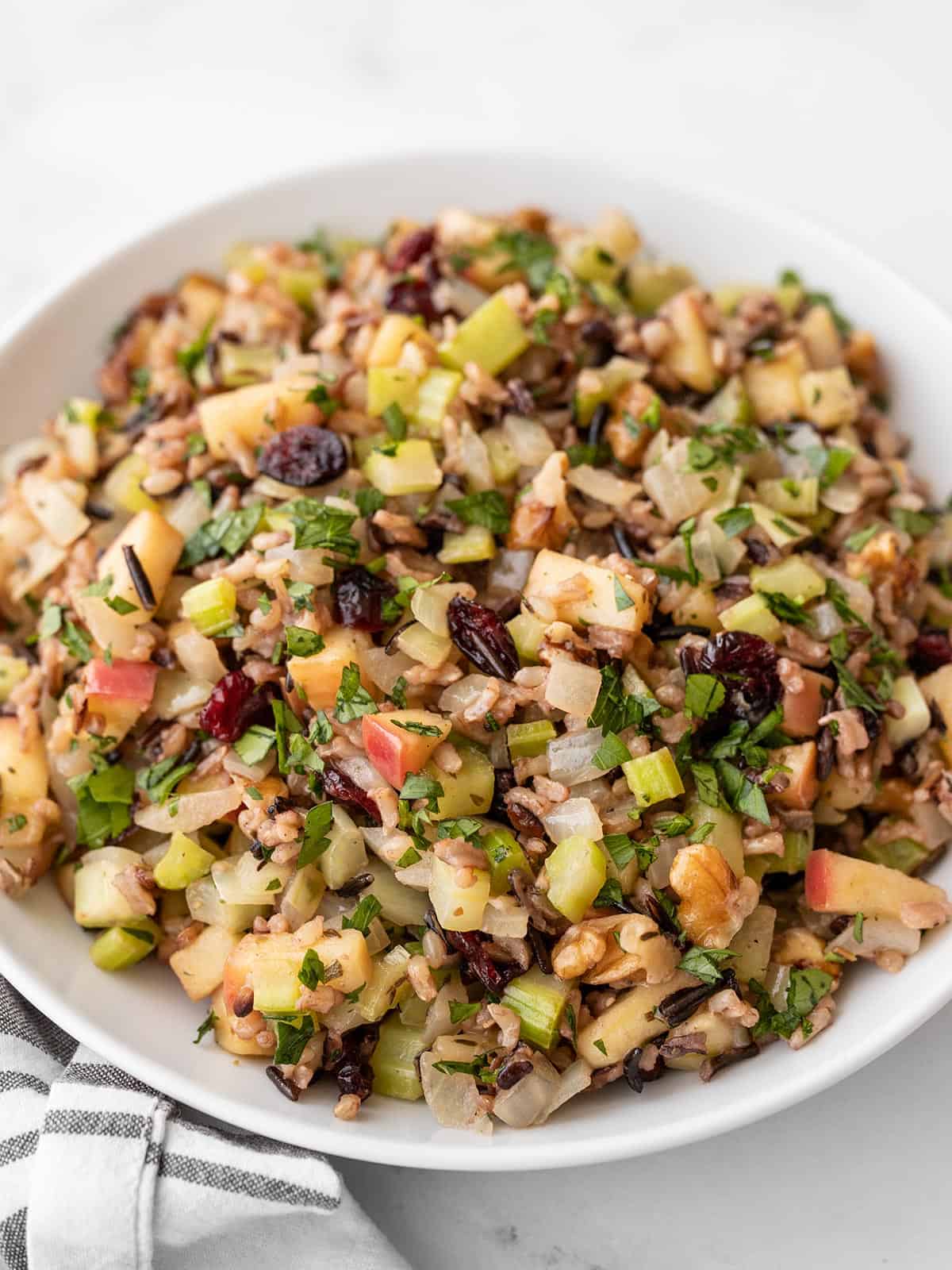 side view of a serving bowl full of wild rice pilaf