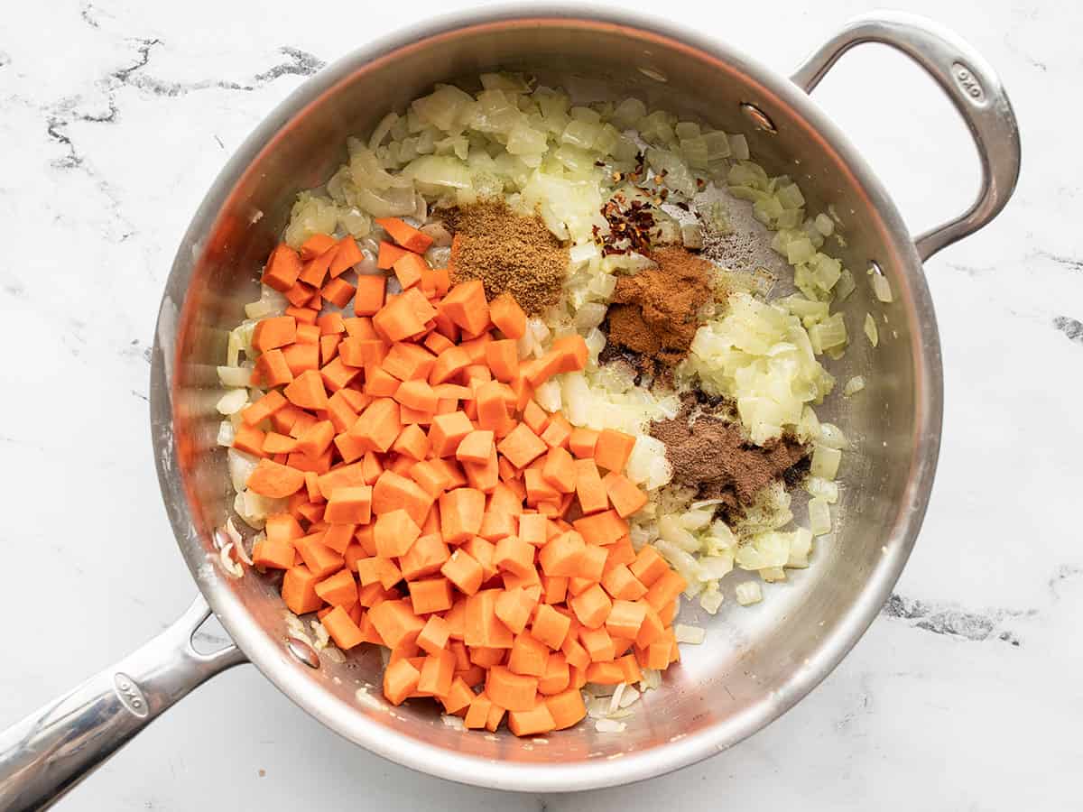 Carrots and spices added to the skillet