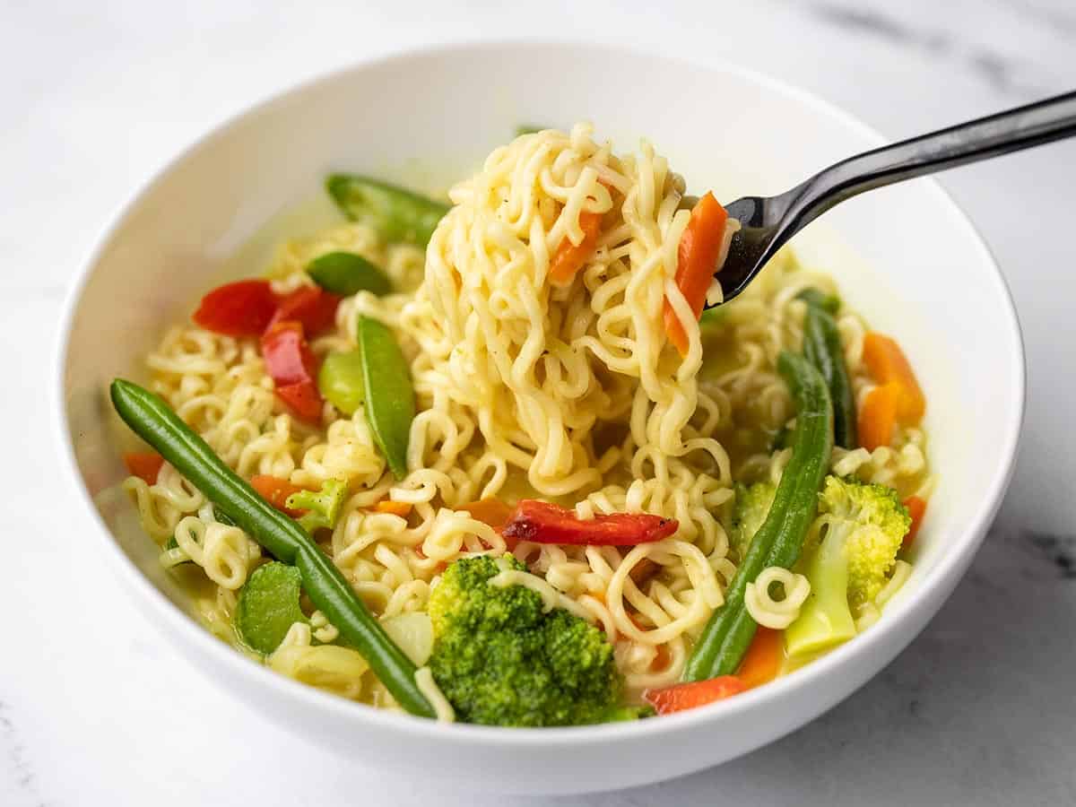 a fork lifting ramen noodles from the bowl