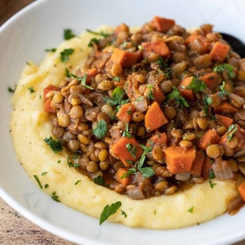 side view of spiced lentils on a bed of polenta