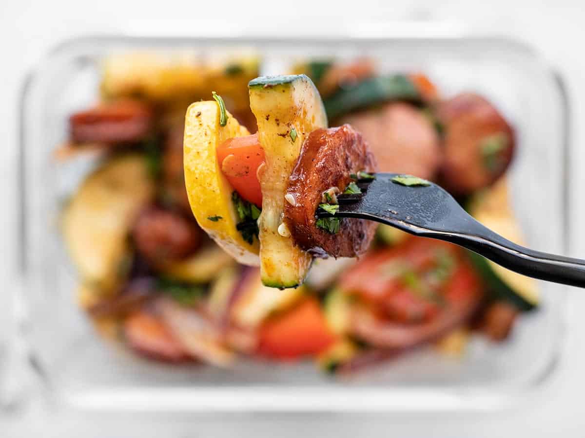 Close up of a forkful of Cajun sausage and Vegetables