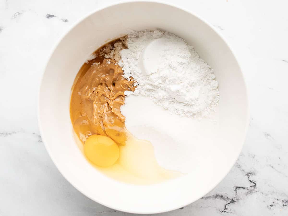 peanut butter cookie ingredients in a bowl, unmixed.