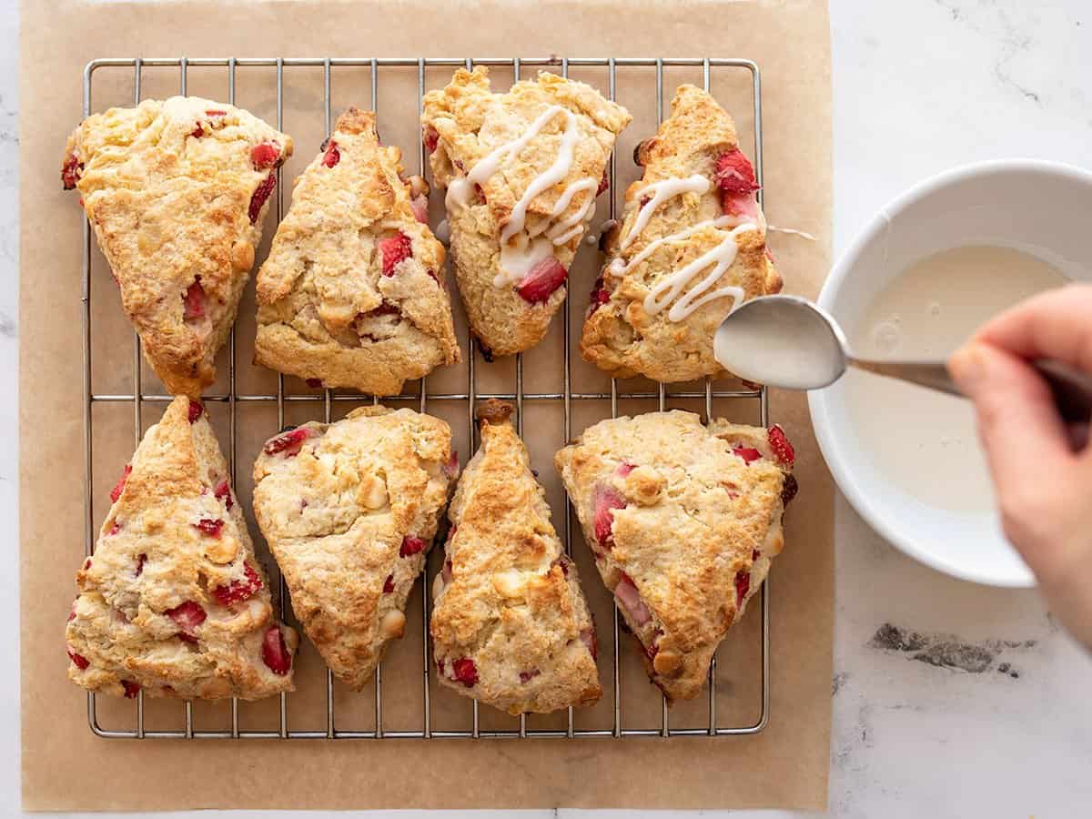 Glaze being drizzled over the scones