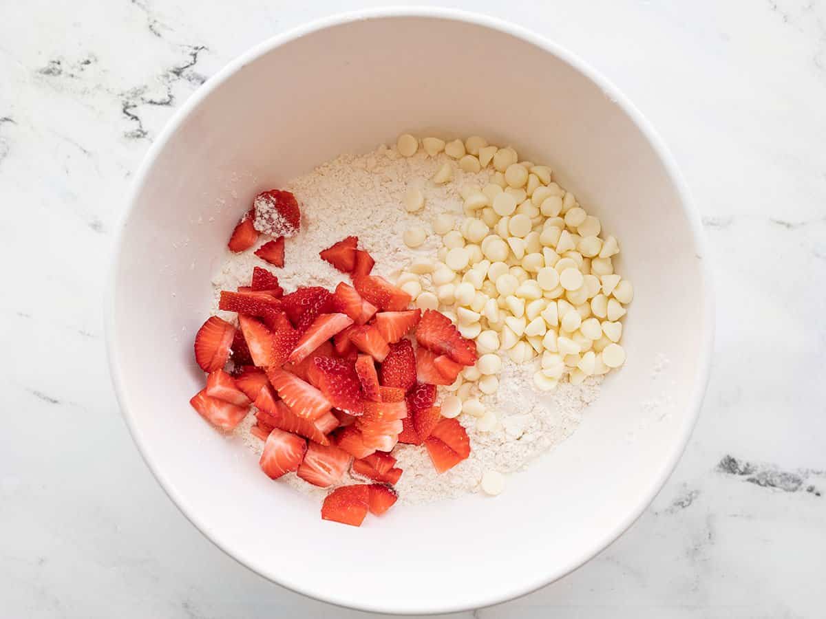 Sliced strawberries and white chocolate chips added to the flour