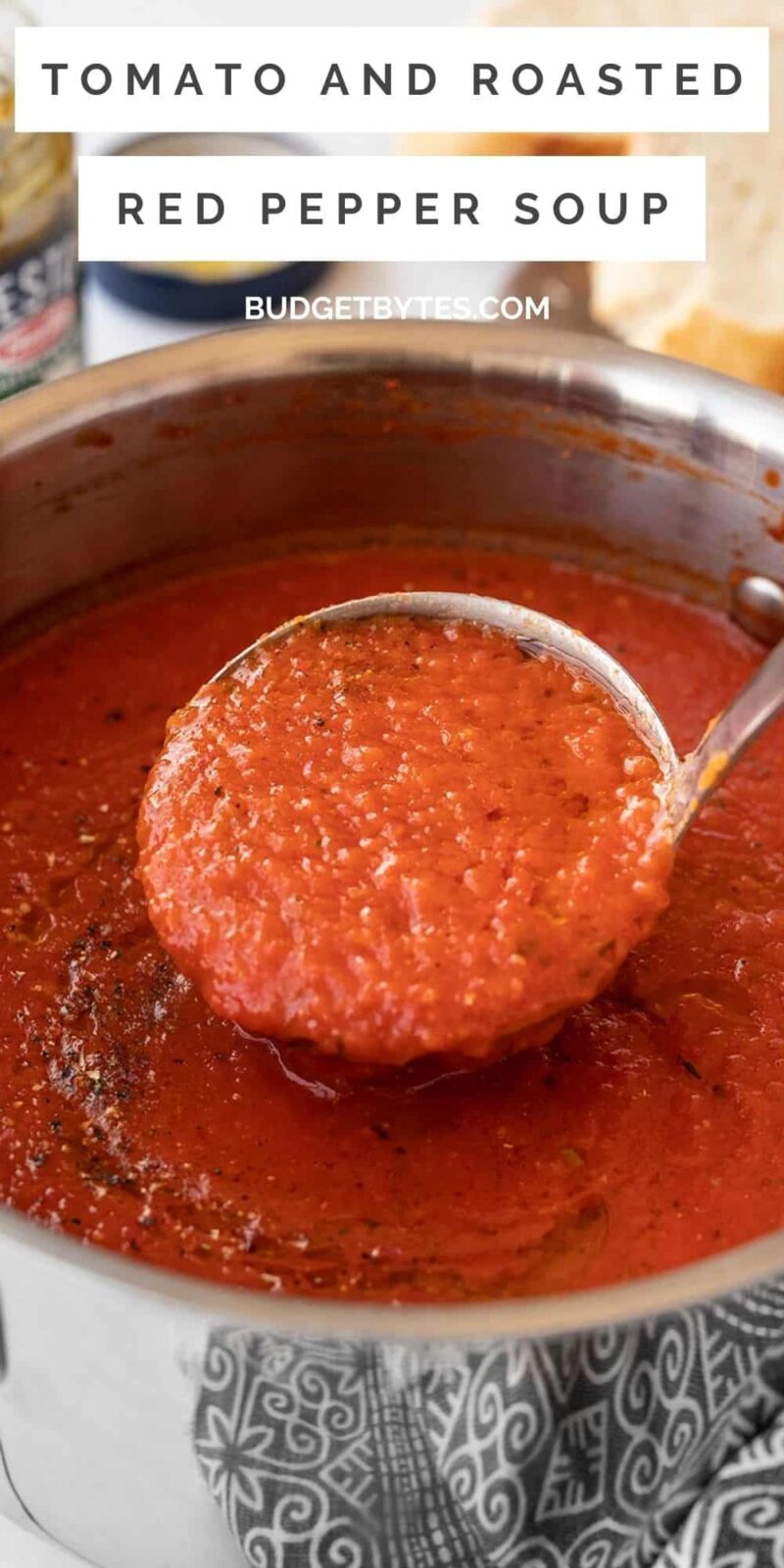 A ladle full of roasted red pepper soup being lifted from the pot.