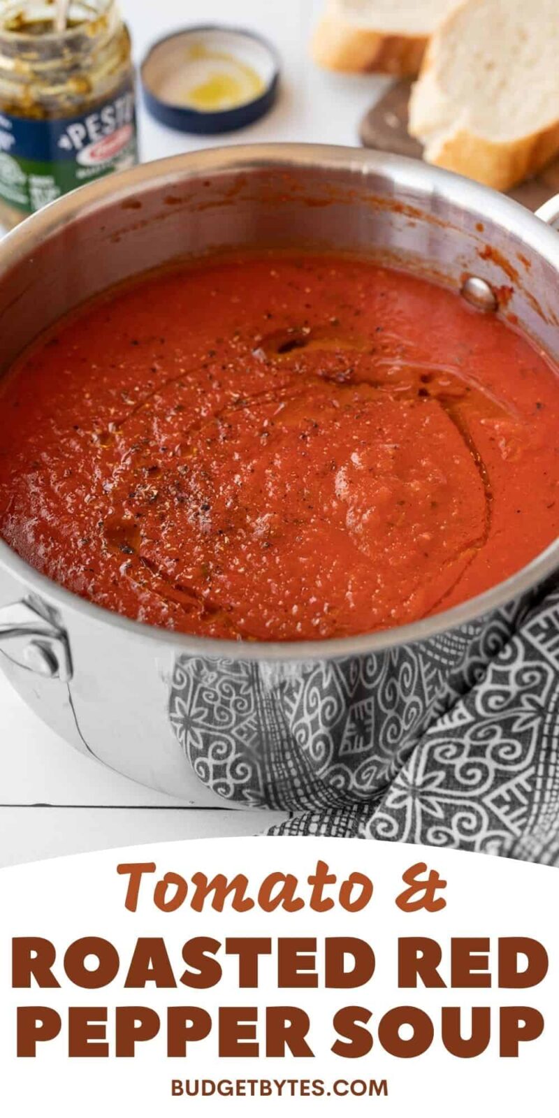 Side view of a pot of tomato and roasted red pepper soup.