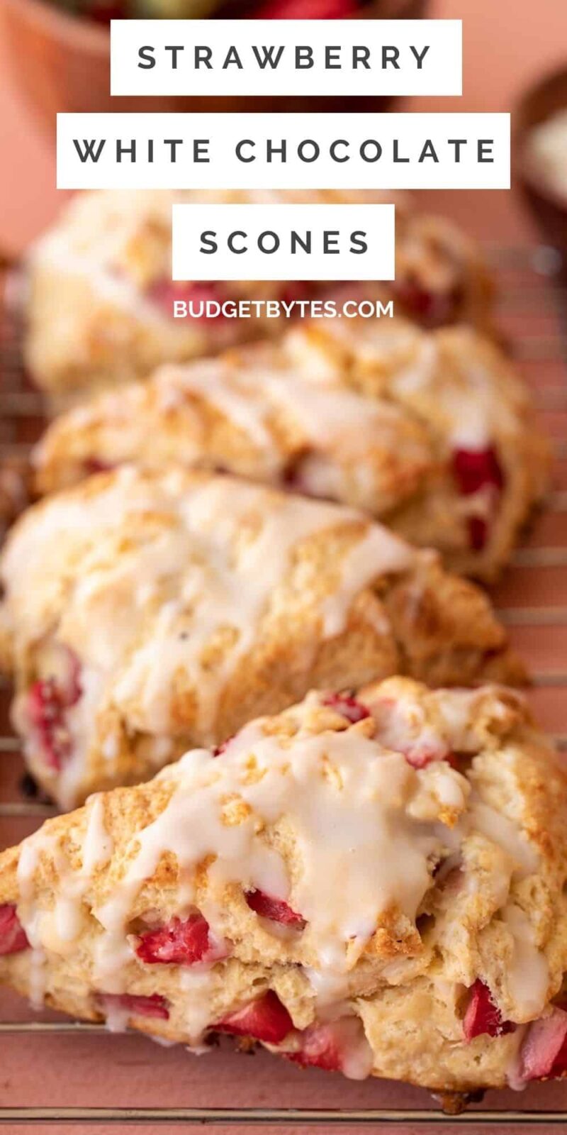 Glaze being drizzled onto strawberry scones